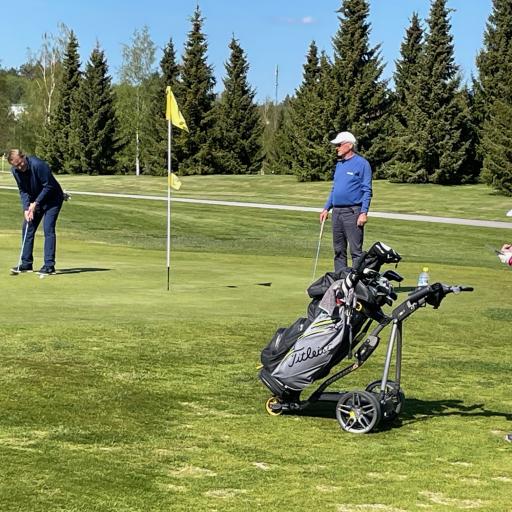  Arto Tikkanen puttaamassa 18. reiällä, Martti Raunio ja Heikki Hallanoron caddie tarkkailevat.